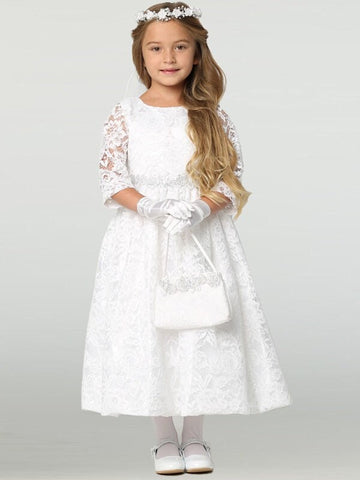 A girl wearing a timeless white First Communion Dress made of lace with 3/4 sleeves and silver corded floral trim on the waist.