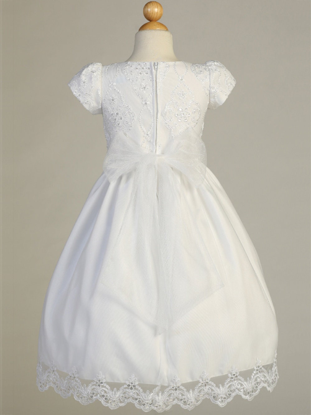 A view of the tulle skirt with corded and embroidered trim.