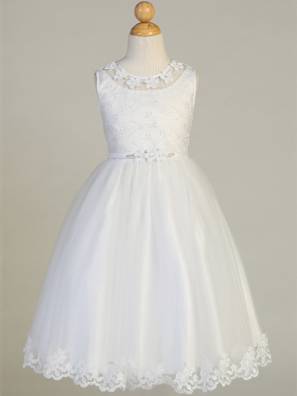 A full-length view of the First Communion Dress showing the tea-length and elegant silhouette.