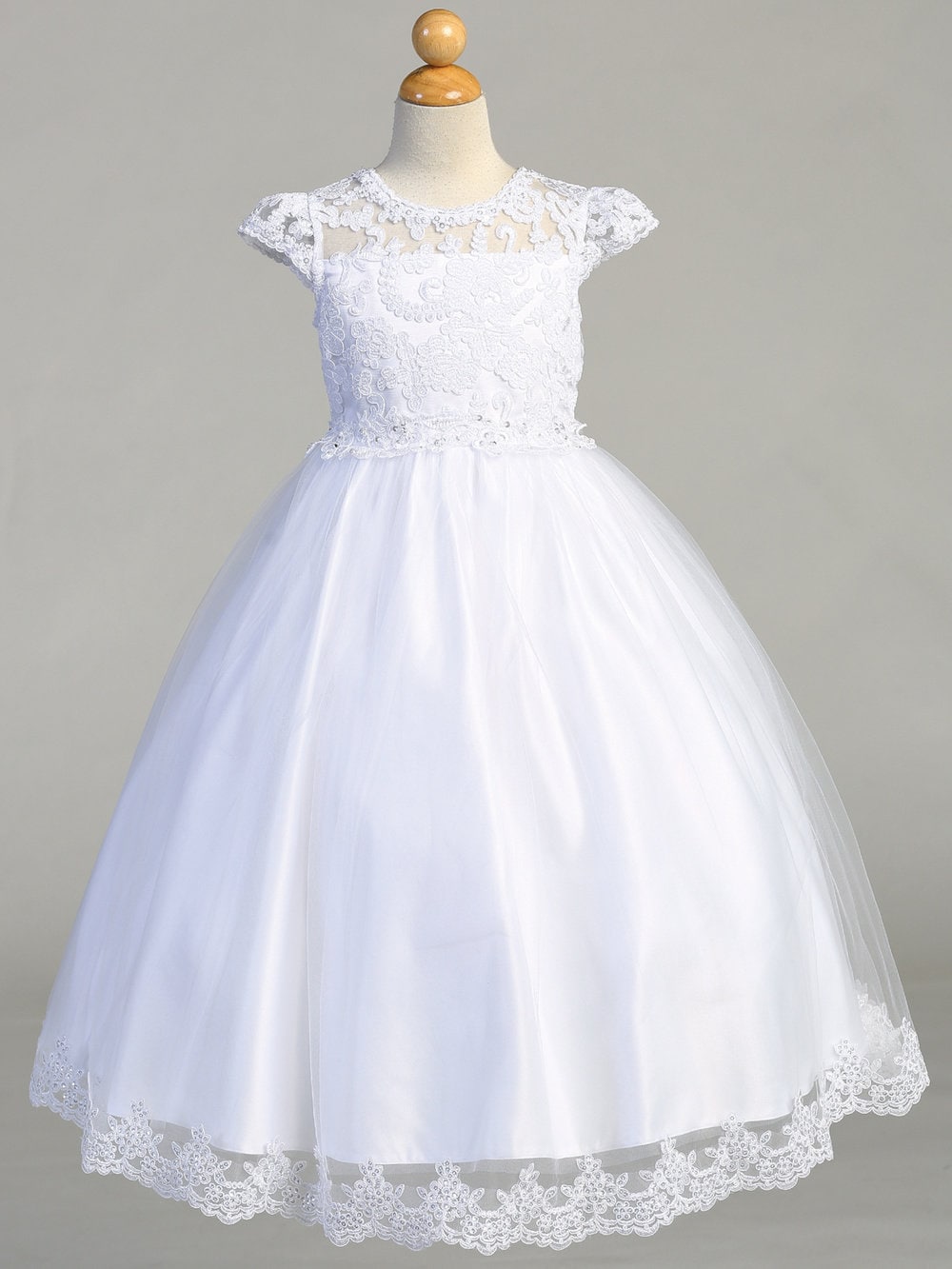 A side view of the First Communion Dress showing the cap sleeves and the tea-length of the dress.