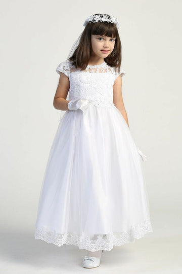 A girl wearing a beautiful white First Communion Dress with embroidered lace on tulle, adorned with beads and sequins.